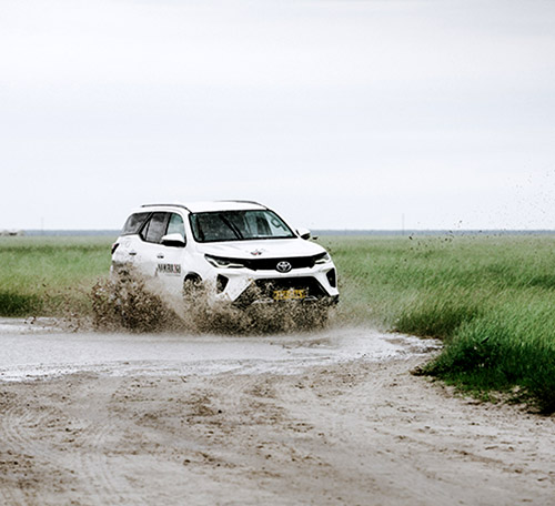 Driving in Namibia, Fortuner in puddle, photo: ArtByEmidio