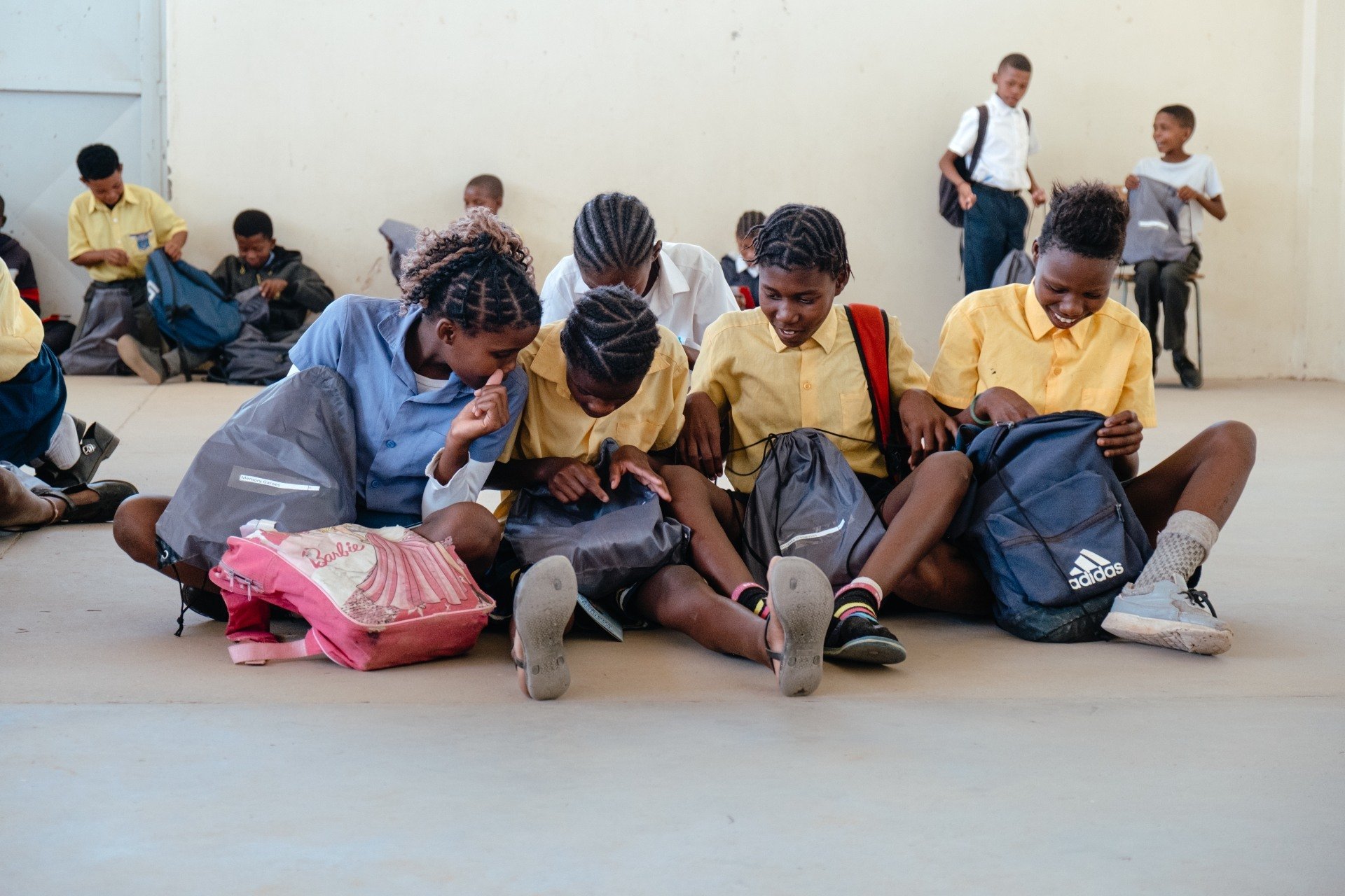 School kids looking at schoolbags after receiving donations through Gondwana Care Trust Namibia and Help4Nam