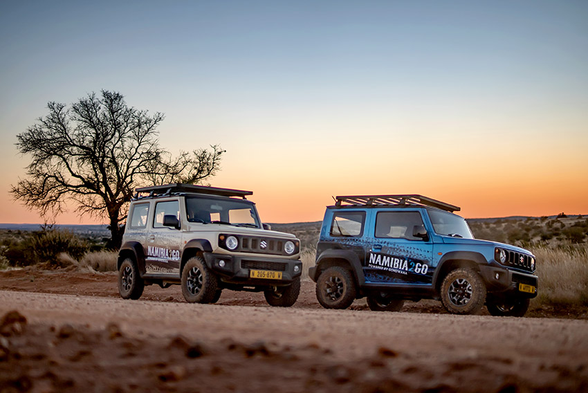 Two Suzuki Jimny rental cars in Namibia at sunset