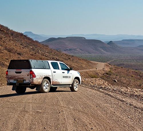 Toyota Hilux Double-Cab 4x4 on gravel road in Namibia